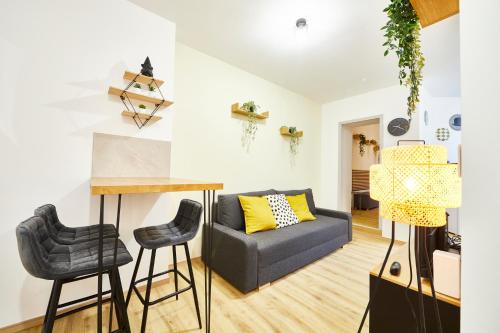 un salon avec un canapé et une table dans l'établissement BE-0 - Appartement F1 pour 1-2 pers au RDC au centre de Mulhouse, à Mulhouse