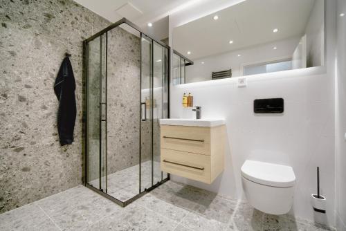 a bathroom with a shower and a toilet and a sink at apartino - FREE parking, 10 minutes walk to city centre, nespresso, netflix in Brno