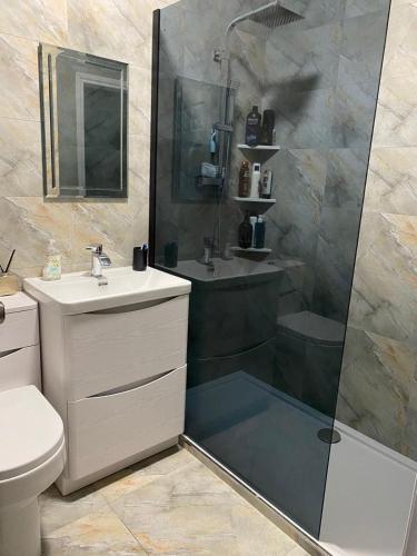 a bathroom with a shower and a sink at The Barn in Hawkhead
