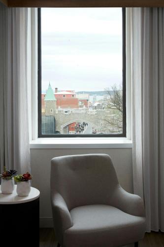 a chair sitting in front of a large window at Marriott Quebec City Downtown in Quebec City