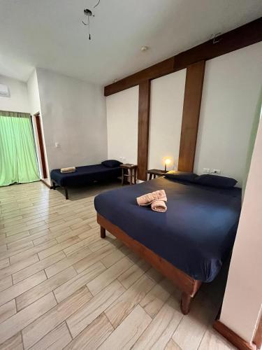 a bedroom with a bed and a living room with a couch at Balu Hotel in Isla Mujeres