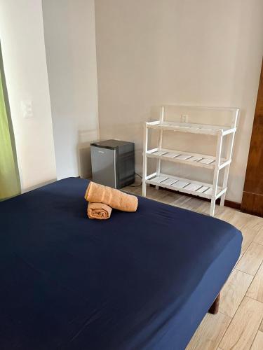 a bedroom with a bed with a towel on it at Balu Hotel in Isla Mujeres