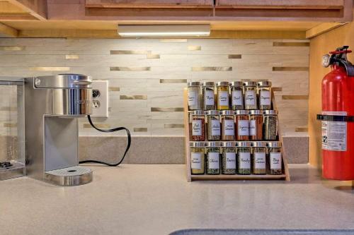 a counter top with a spice rack next to a fire extinguisher at Downtown Helen Walk To Shops And Restaurants in Helen
