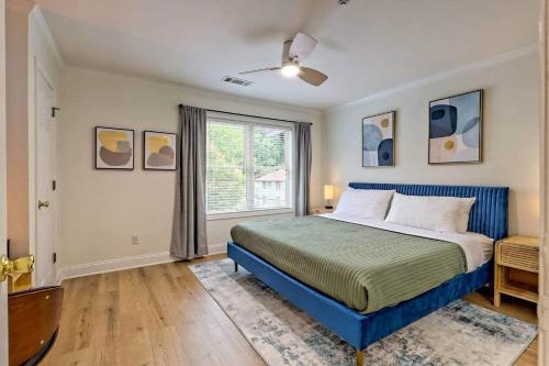 a bedroom with a blue bed and a window at Downtown Helen Walk To Shops And Restaurants in Helen