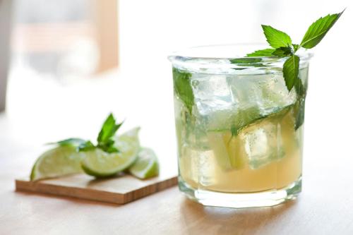 a glass of lemonade with lime and mint on a table at Courtyard by Marriott Cocoa Beach Cape Canaveral in Cocoa Beach