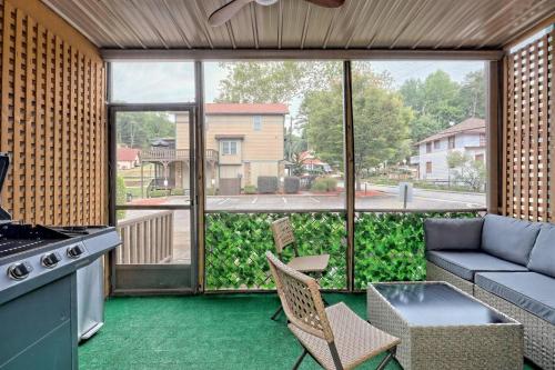 a kitchen with a view of a patio with a couch at Charming Downtown Helen Getaway in Helen