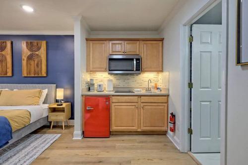 a small kitchen with a red refrigerator next to a bed at Charming Downtown Helen Getaway in Helen