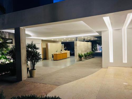 an office lobby with a reception desk and potted plants at Casa Begonias Hotel mas Villas in Jiutepec