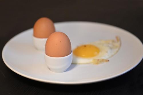 two eggs on a white plate on a table at B&B MareLuna in Angri