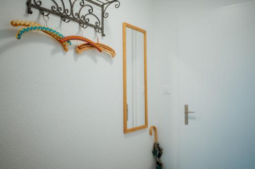 a mirror hanging on a wall next to a cross at Apartment Alpenblick in Amden