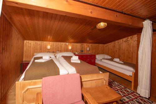 a bedroom with two beds in a wooden cabin at Haus Hahnenbalz Top 1 in Krimml