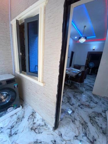 a room with a wall that is covered in marble at Your Elegant Home in Lagos