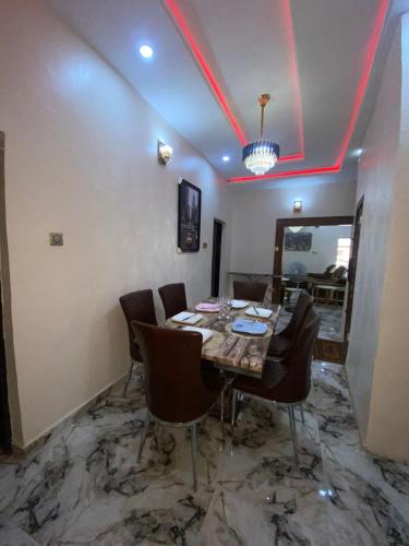 a dining room with a table and some chairs at Your Elegant Home in Lagos