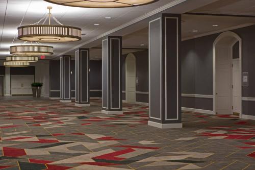 a lobby with columns and chandeliers in a building at College Park Marriott Hotel & Conference Center in College Park