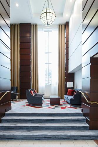 a lobby with chairs and a large window at College Park Marriott Hotel & Conference Center in College Park