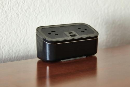 a black device sitting on top of a wooden table at Courtyard St. Louis Westport Plaza in Maryland Heights