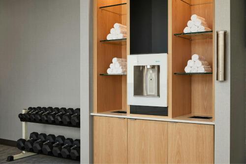 a room with a kitchen with a microwave at Courtyard St. Louis Westport Plaza in Maryland Heights
