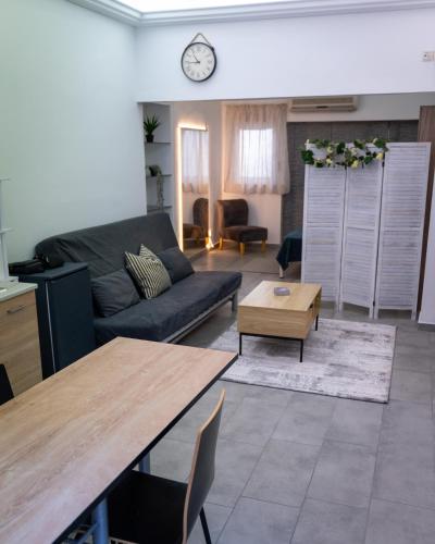 a living room with a couch and a table at Bill and Dim in Xrisoupoli in Chrysoupolis