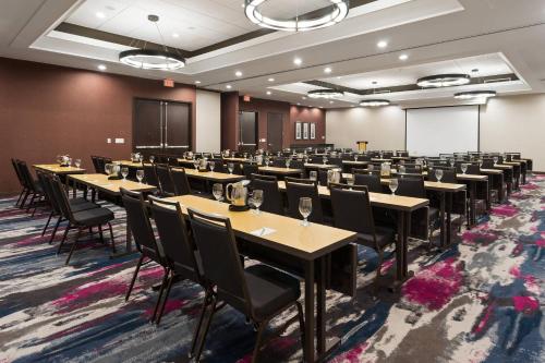 a conference room with tables and chairs and a whiteboard at Courtyard Miami Downtown Brickell Area in Miami