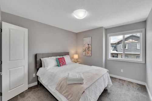 a bedroom with a large bed and a window at Luxury family vacation rental in Laurel Edmonton in Edmonton