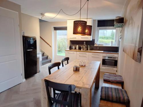 a kitchen with a wooden table and some chairs at Holiday Home in Grou near Frisian Lakes in Grou