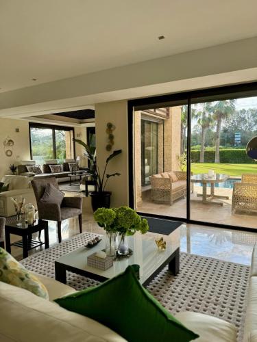 a living room with a couch and a table at Mazagan private villa in El Jadida