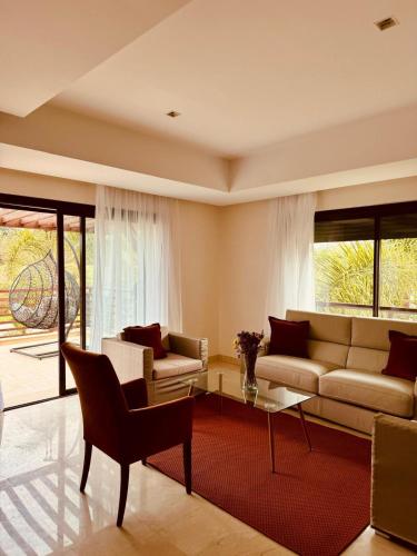 a living room with a couch and a table at Mazagan private villa in El Jadida