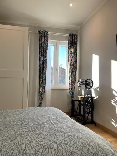 a bedroom with a bed and a window at Il Campanile in Tivoli