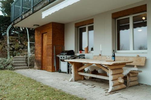 a picnic table sitting outside of a house at Apartment Bergzauber in Amden