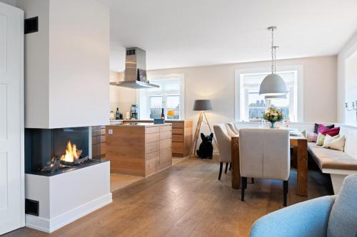 a living room and dining room with a fireplace at Watthaus 1 in Tinnum