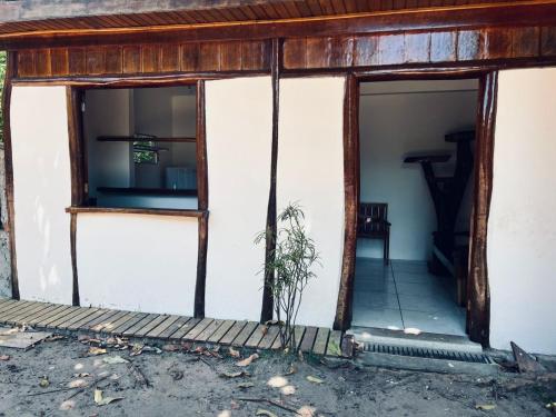 an outside view of a house with the door open at Kitnet Gildmar in Marau