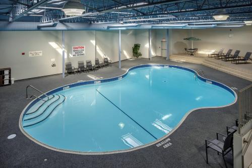 a large swimming pool in a building with chairs at Fairfield Inn & Suites by Marriott Belleville in Belleville