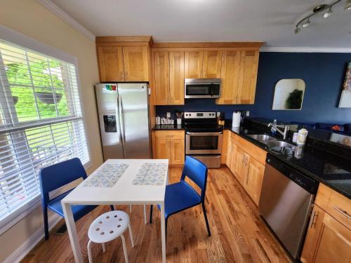 a kitchen with a white table and blue chairs at Amazing ATL downtown houses - minutes walk to bars, food and transport! in Atlanta