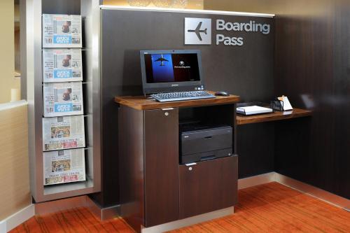 a desk with a computer on top of it at Courtyard by Marriott Oklahoma City Airport in Oklahoma City