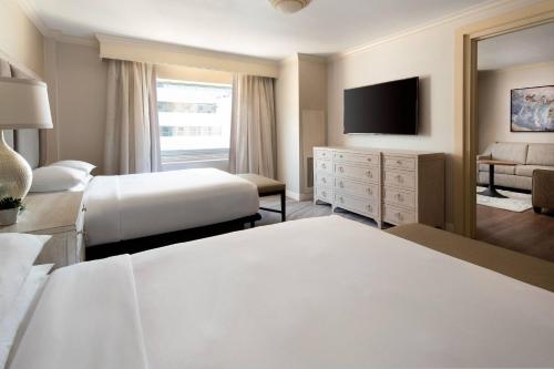 a hotel room with two beds and a flat screen tv at Marriott Salt Lake City Center in Salt Lake City