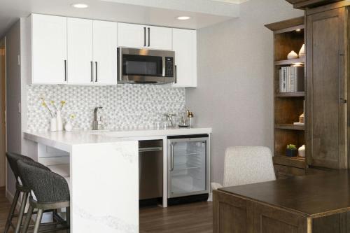 a kitchen with white cabinets and a counter top at Marriott Salt Lake City Center in Salt Lake City