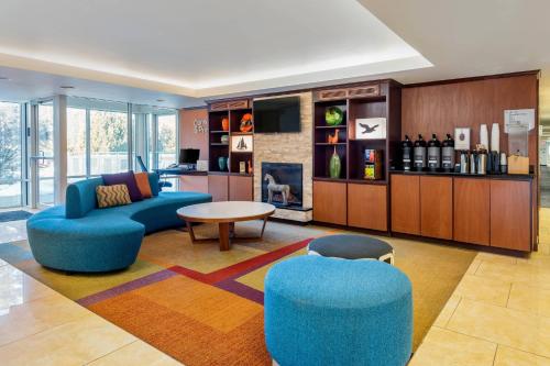 a living room with a couch and chairs and a table at Fairfield by Marriott Inn & Suites Portland Maine Airport in Scarborough