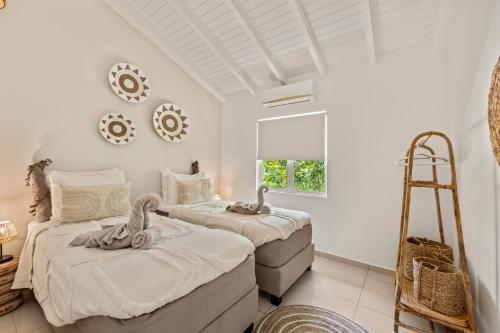 Postel nebo postele na pokoji v ubytování Villa Noni Curaçao met jacuzzi