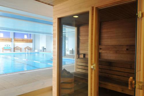 a view of a swimming pool from the door of a house at Renaissance Tel Aviv Hotel in Tel Aviv