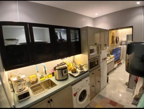 a kitchen with a sink and a stove top oven at best rest apartments - 3 in Riyadh