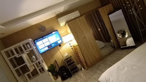 a hotel room with a television on the wall at best rest apartments - 3 in Riyadh