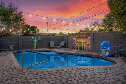 a swimming pool in a backyard with a basketball hoop at Basketball Court & Heated Pool, 1 Mi To Old Town! in Scottsdale