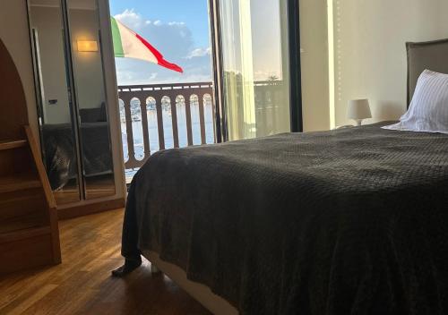 a bedroom with a bed and a large window at Hotel Europa in Taranto