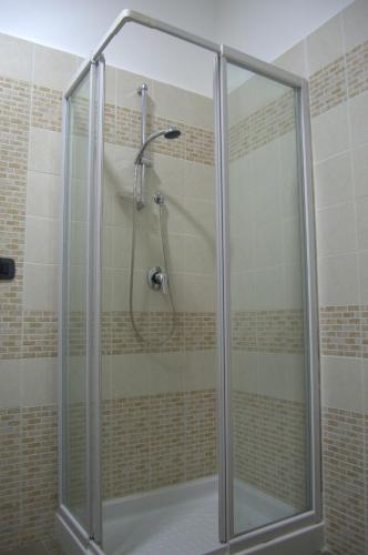 a shower with a glass door in a bathroom at Civico 83 in Reggio Calabria