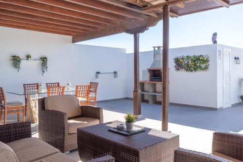 a patio with chairs and a table and a grill at Apartment Orquidia - Rural Guest Apartment in Tías