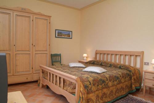 a bedroom with a large bed with two pillows on it at Carlino Vacanze in Gaiole in Chianti