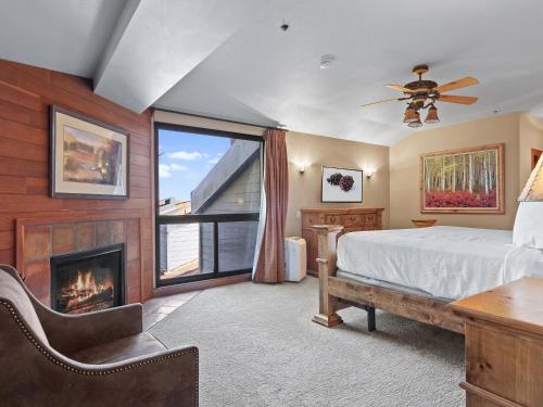 a bedroom with a bed and a fireplace at Silver King by All Seasons Resort Lodging in Park City