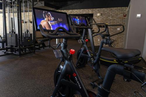 a gym with bikes and a flat screen tv at Courtyard by Marriott Reno in Reno