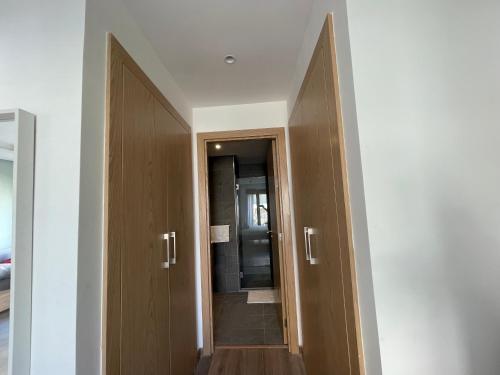 pasillo con 2 puertas de madera y espejo en Charmant studio avec vue sur mer, en Rabat