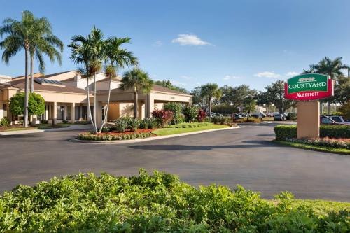 a sign for a car dealership in a parking lot at Courtyard by Marriott Fort Myers Cape Coral in Fort Myers